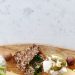 Top view of a gourmet cheese and cracker platter with nuts, ideal for healthy snacking and elegant serving.